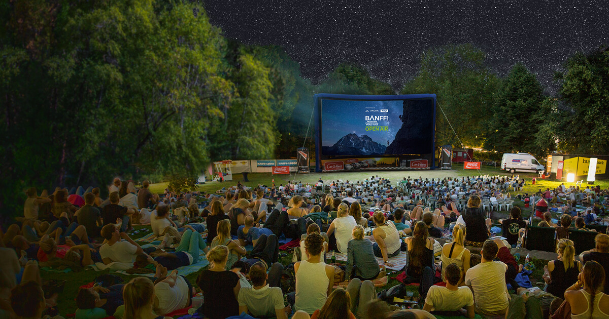 Banff Tour 2026 Open Air &ndash; Open-air audience on a lawn in front of an inflatable Banff Tour screen during a screening under a starry sky.